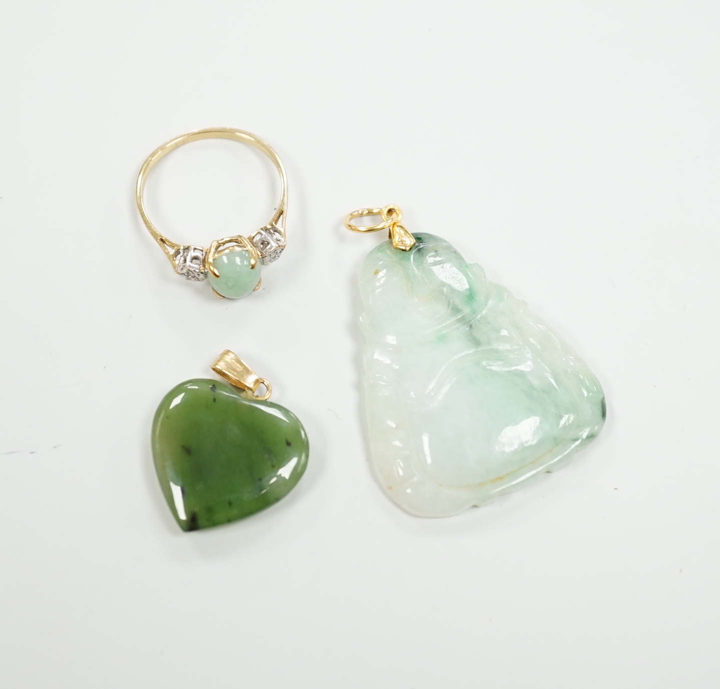 Two mounted jade pendants, including heart shaped nephrite and a 9ct gold, simulated jade and diamond chip set ring.